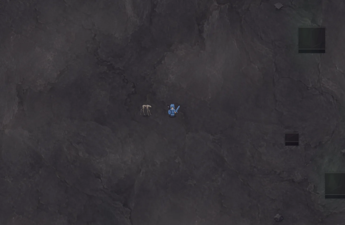A development view beneath the surface: dark rock, mine openings, a creature and the player.